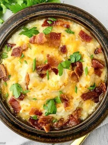 a bowl of instant pot mashed cauliflower with bacon and cheese