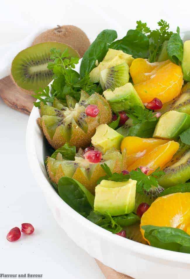close up view of Kiwi Mandarin Spinach Salad showing kiwi flowers