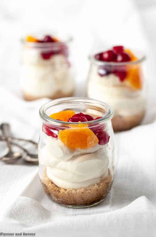 3 jars of gluten-free Mini No-Bake Cranberry Orange Cheesecake in small glasses