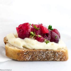 Close up view of a Cranberry Whipped Ricotta Crostini appetizer.