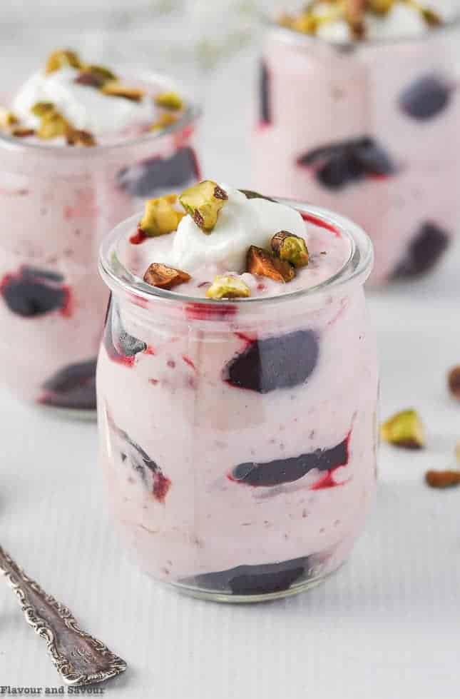 Close up view of Light Cherry Coconut Yogurt Fool garnished with pistachio nuts.