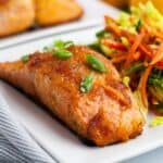 Citrus Glazed Salmon with Sake on a plate with coleslaw