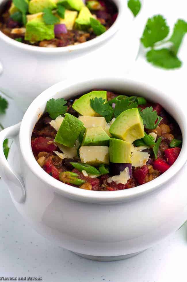 a bowl of chili garnished with avocado cubes