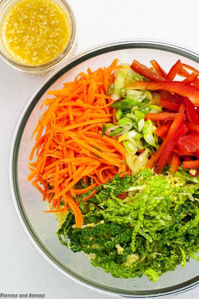 ingredients for Crunchy Cabbage Coleslaw with Sesame Miso Dressing in a glass bowl