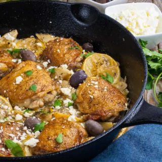 One Pan Baked Lemon Artichoke Chicken Thighs in a cast iron skillet