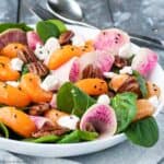 watermelon radish salad with spinach, oranges, goat cheese and pecans