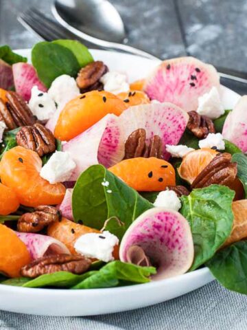 watermelon radish salad with spinach, oranges, goat cheese and pecans