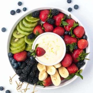Creamy Lemon Curd Fruit Dip surrounded by berries and fruit
