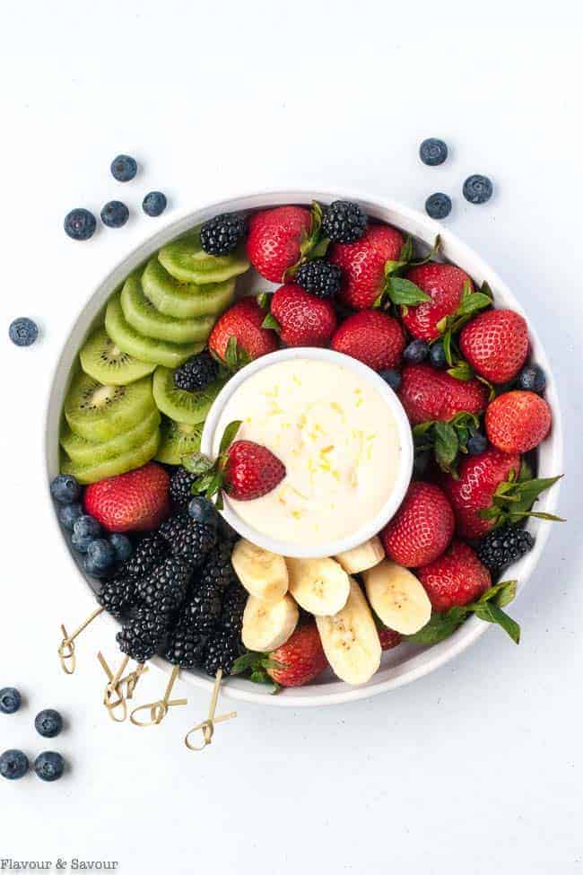 Creamy Lemon Curd Fruit Dip surrounded by berries and fruit