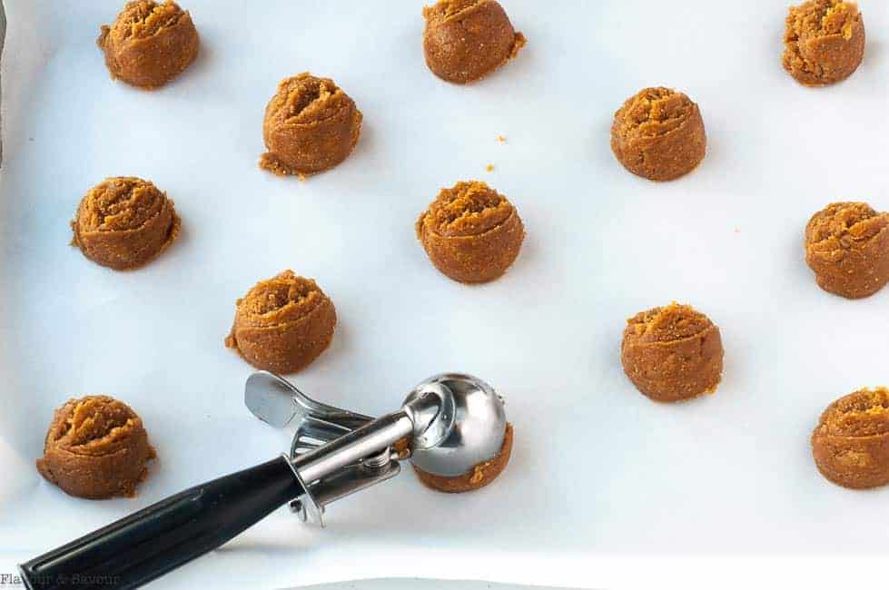 Using a cookie scoop to put cookies on a baking sheet