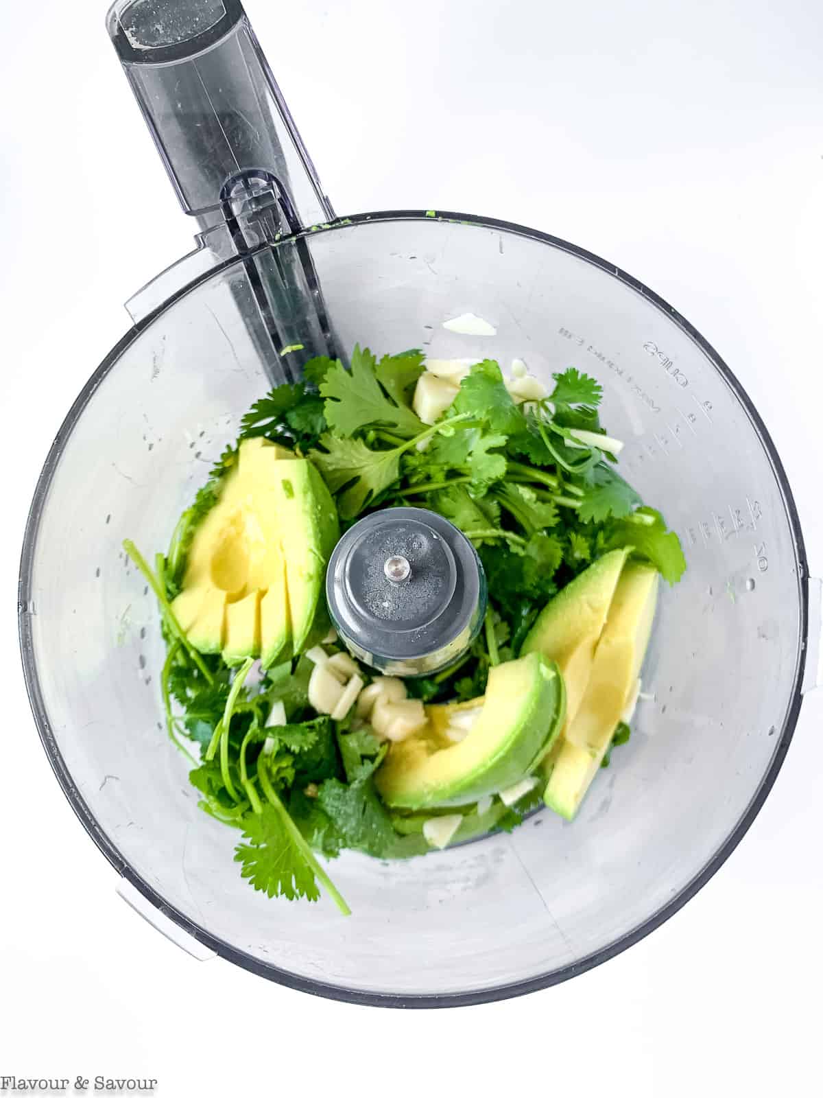 Avocado cream ingredients in the bowl of a food processor.