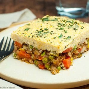 A serving of Shepherd's pie with mashed cauliflower crust on a plate.