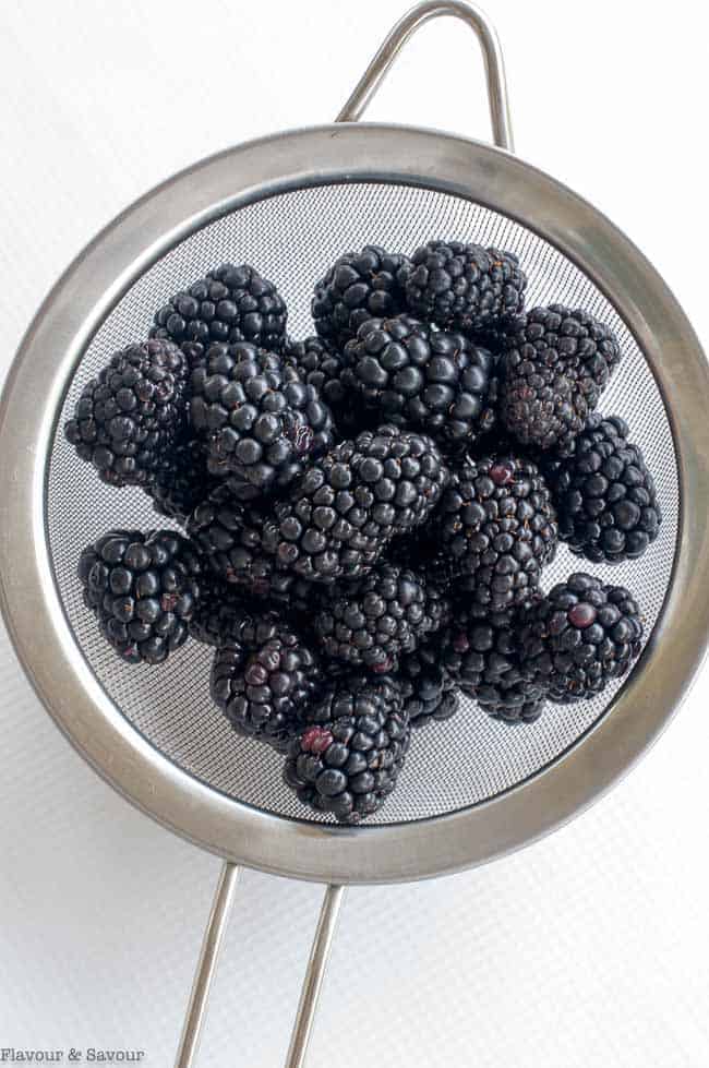 Fresh blackberries in a sieve.