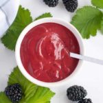 Blackberry Balsamic Dressing in a bowl surrounded by fresh blackberries
