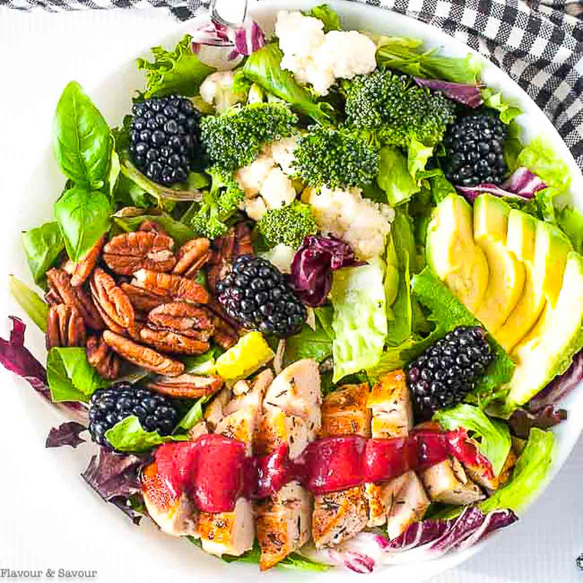 Overhead view of a bowl of blackberry balsamic grilled chicken salad.