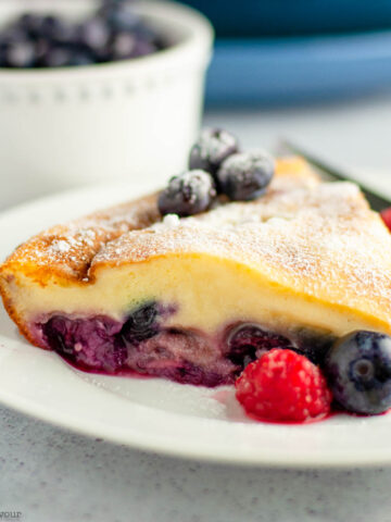 A slice of gluten-free berry clafoutis with cherries.