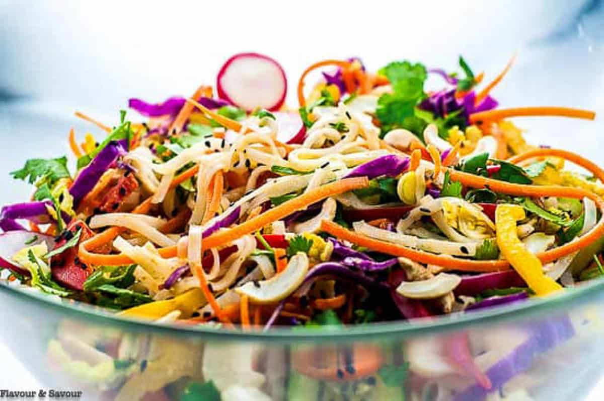 A large bowl of Thai noodle salad with colourful vegetables.