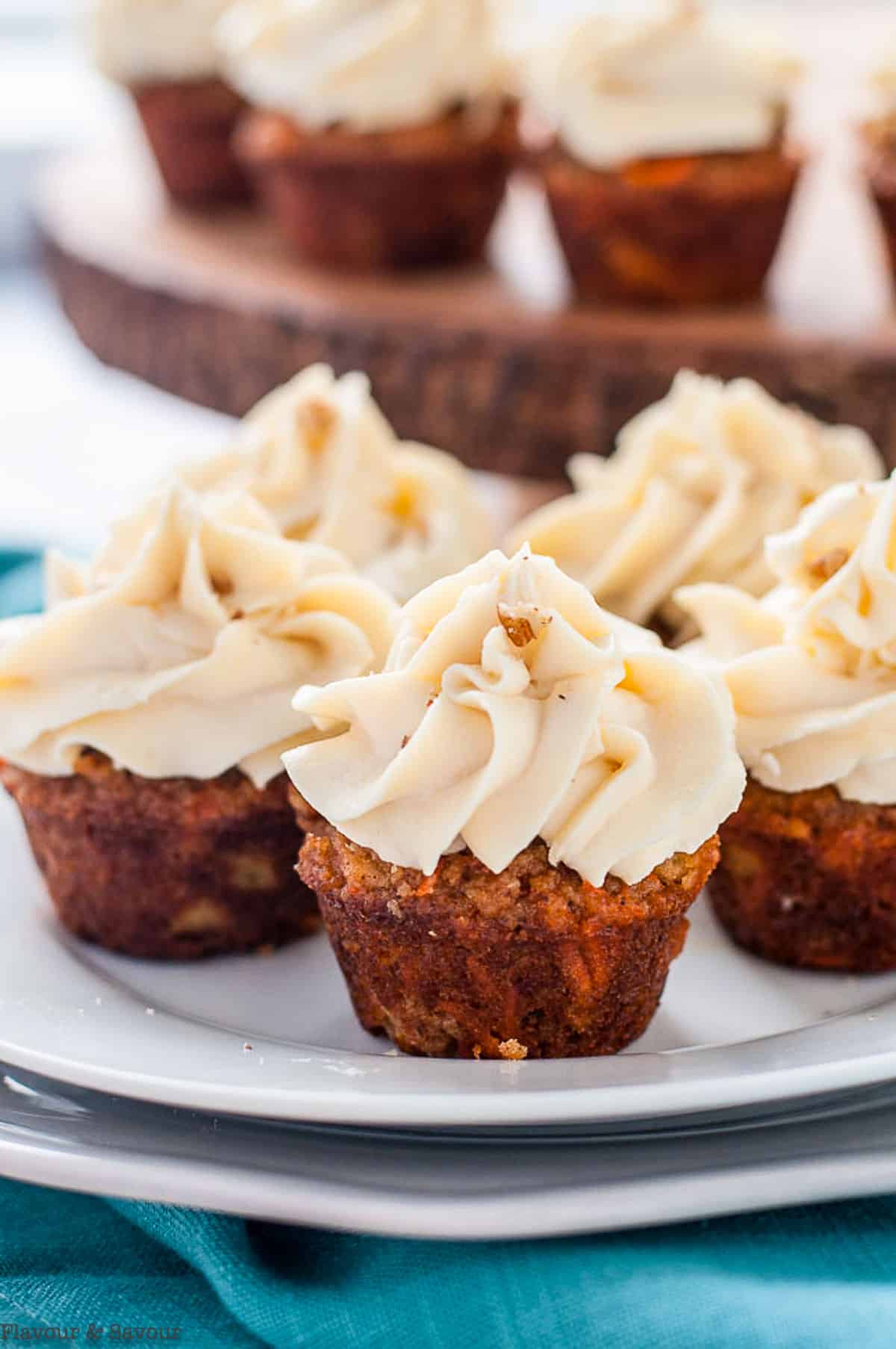 Frosted mini carrot cake cupcakes on a plate