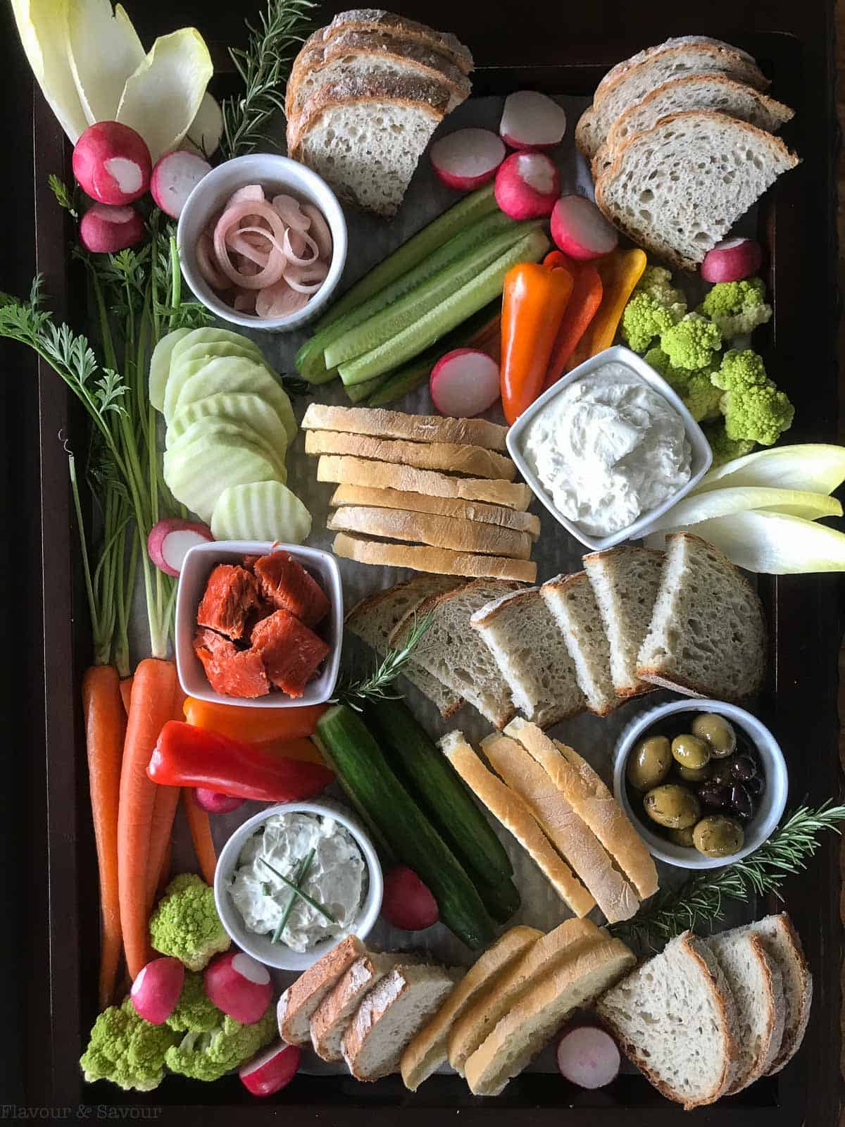 Appetizer Snack Board with veggies, breads, cheese and pickled shallots