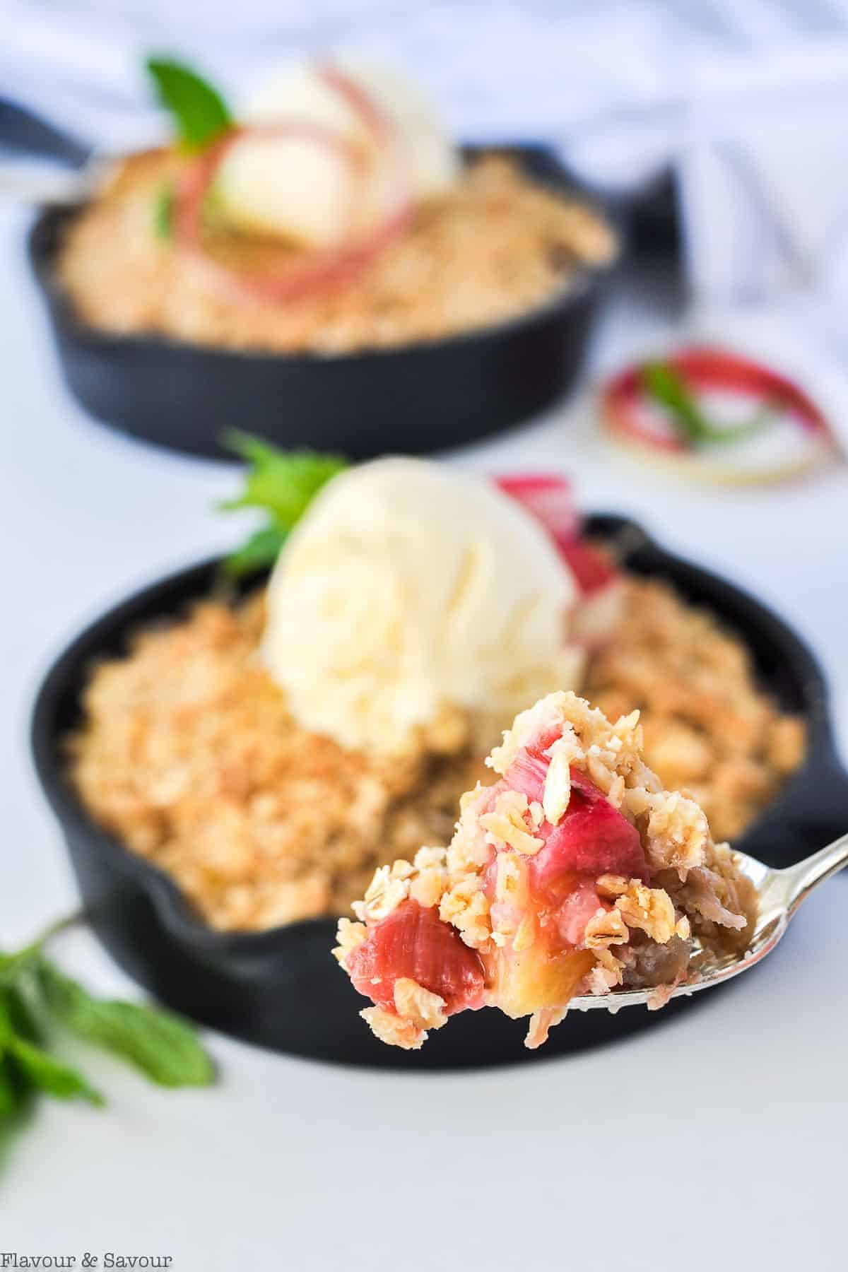 Close up view of a spoonful of Pineapple Rhubarb Crisp