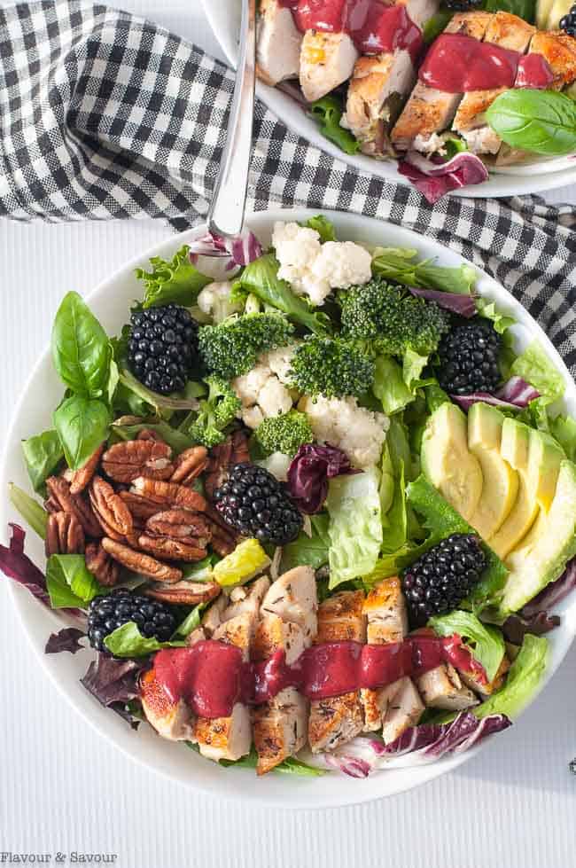 Blackberry Balsamic Grilled Chicken Salad with dressing on a sliced chicken breast