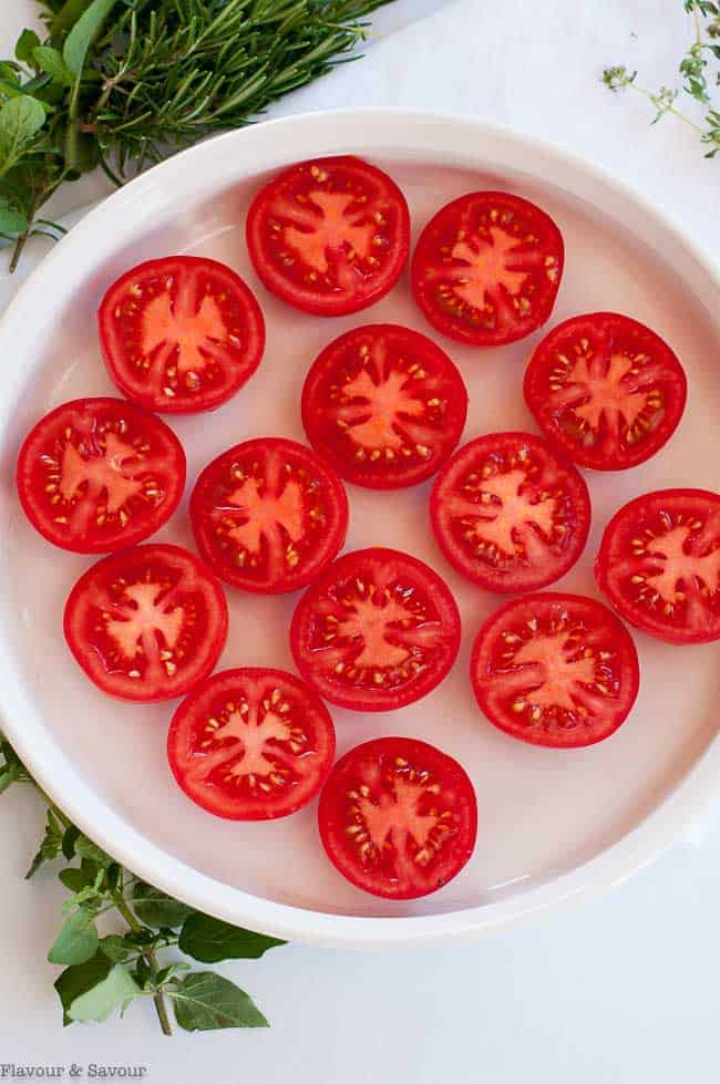 Tomato halves in a baking dish.