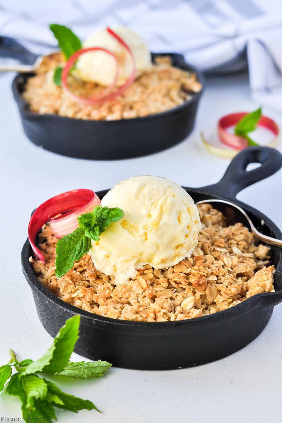 Pineapple Rhubarb Crisp in mini cast iron skillets with ice cream