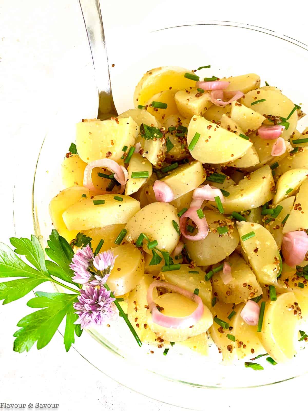 Close up view of Italian potato salad with pickled shallots and snipped chives