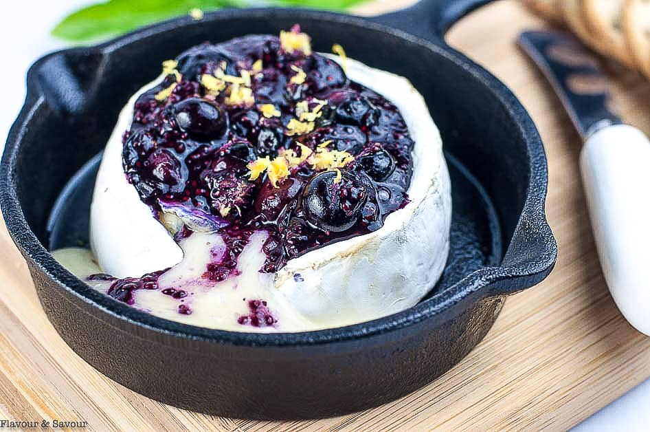 Blueberry Basil Chia Seed Jam on Brie in a small cast iron skillet