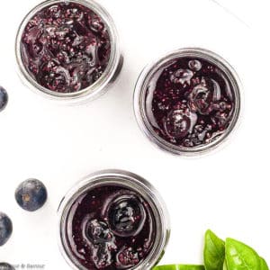 Overhead view of 3 jars of Blueberry Basil Chia see jam in small Mason jars