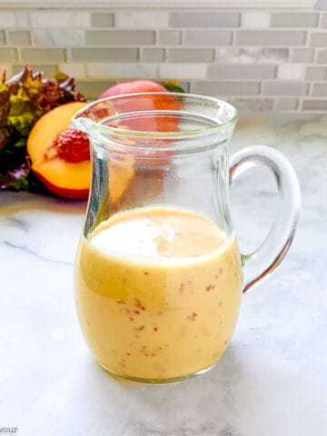 a small pitcher of Sweet Peach Salad Dressing