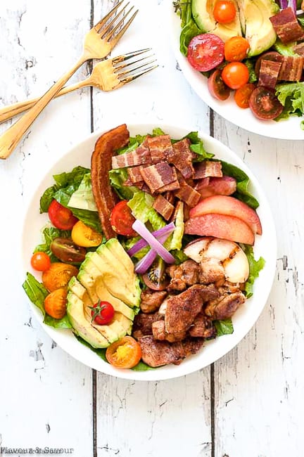 Two bowls of Chicken Cobb Salad with two forks beside