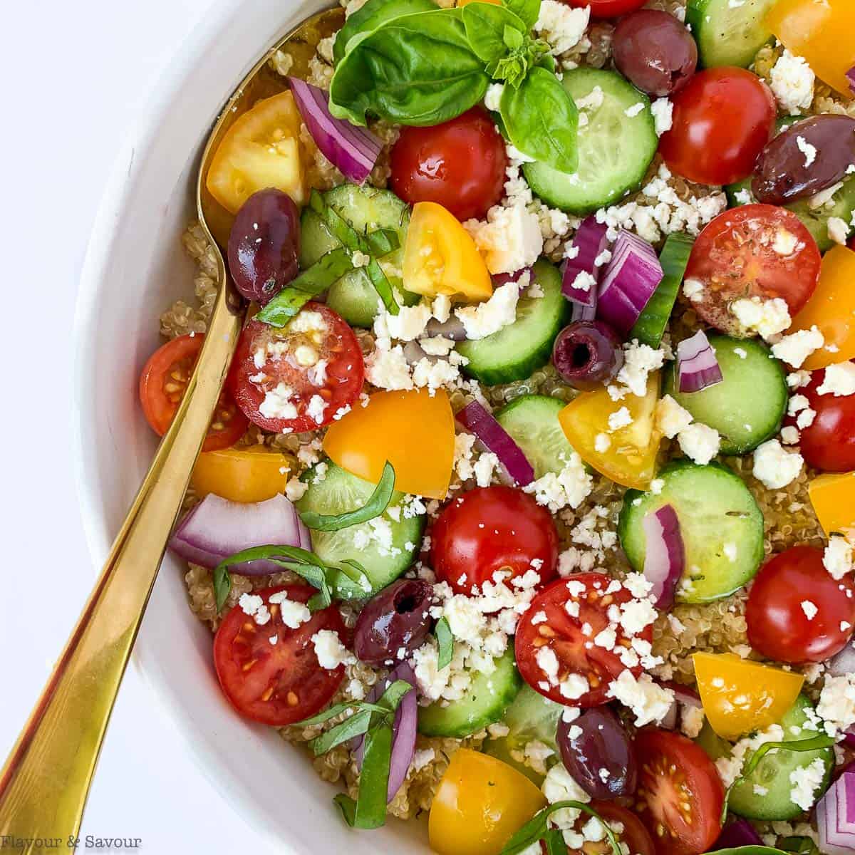 Close up view of Mediterranean Quinoa Salad with cucumbers, tomatoes, olives and feta cheese.