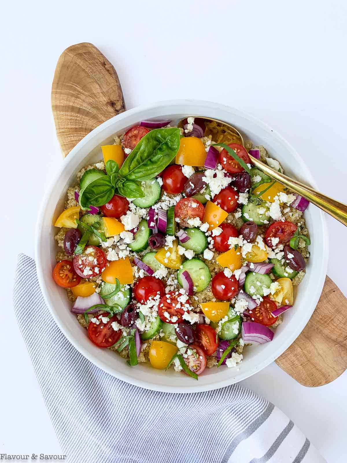 Overhead view of Mediterranean Quinoa Salad in a round white shallow bowl