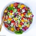 overhead view of Mediterranean Quinoa Salad in a round white shallow bowl