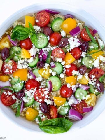 overhead view of Mediterranean Quinoa Salad in a round white shallow bowl