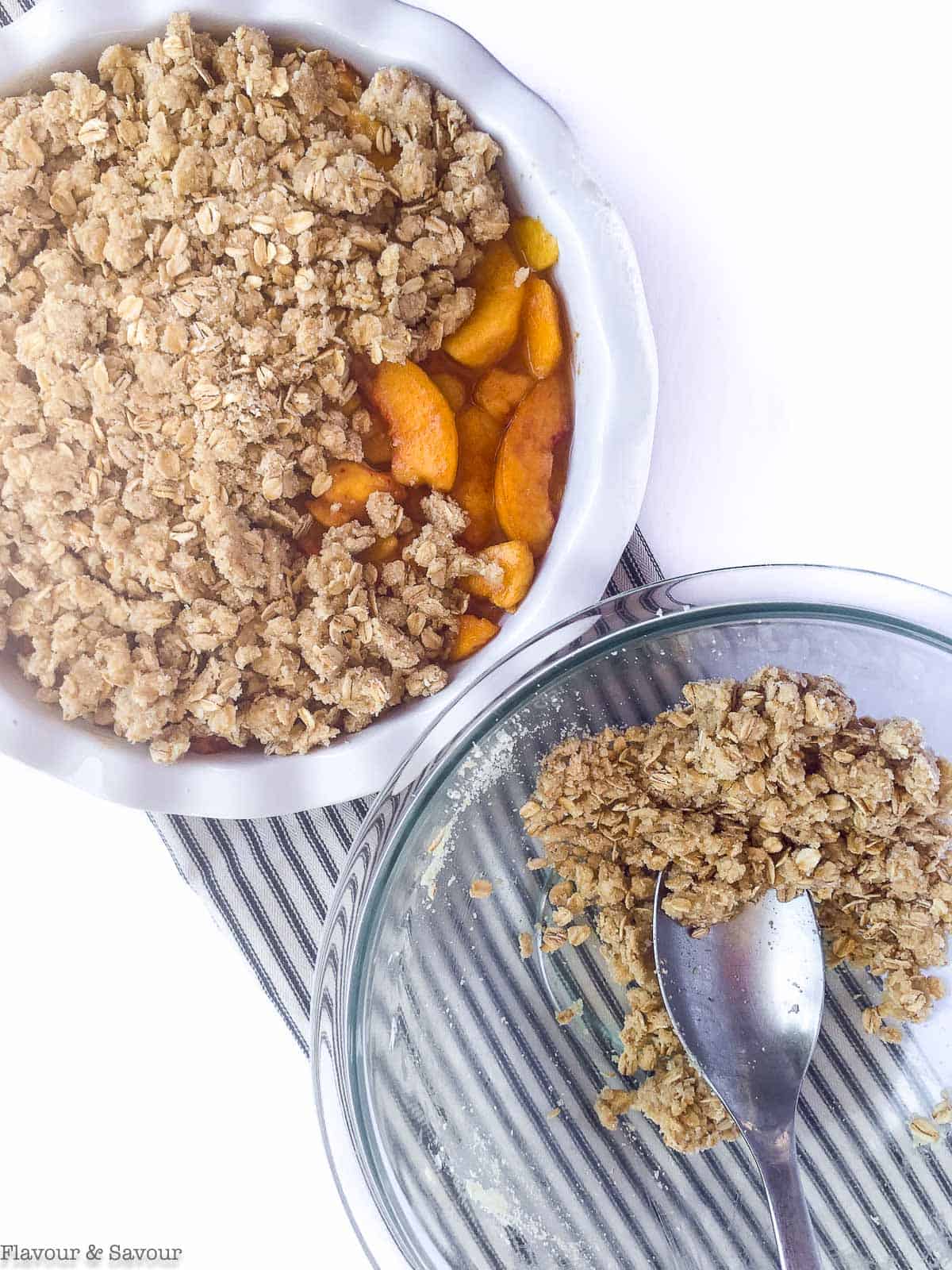 Adding topping to Peach Crisp.