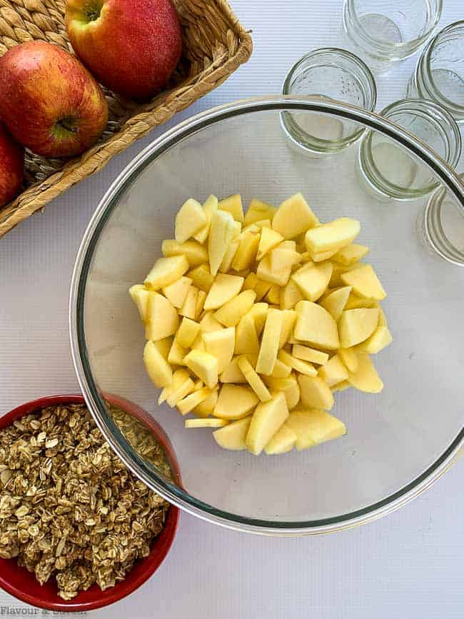 Sliced apples and crisp topping to prepare Apple Blackberry Crisp in Mason Jars.