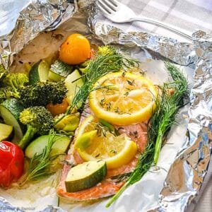 Wild salmon and vegetables cooked in a foil packet.