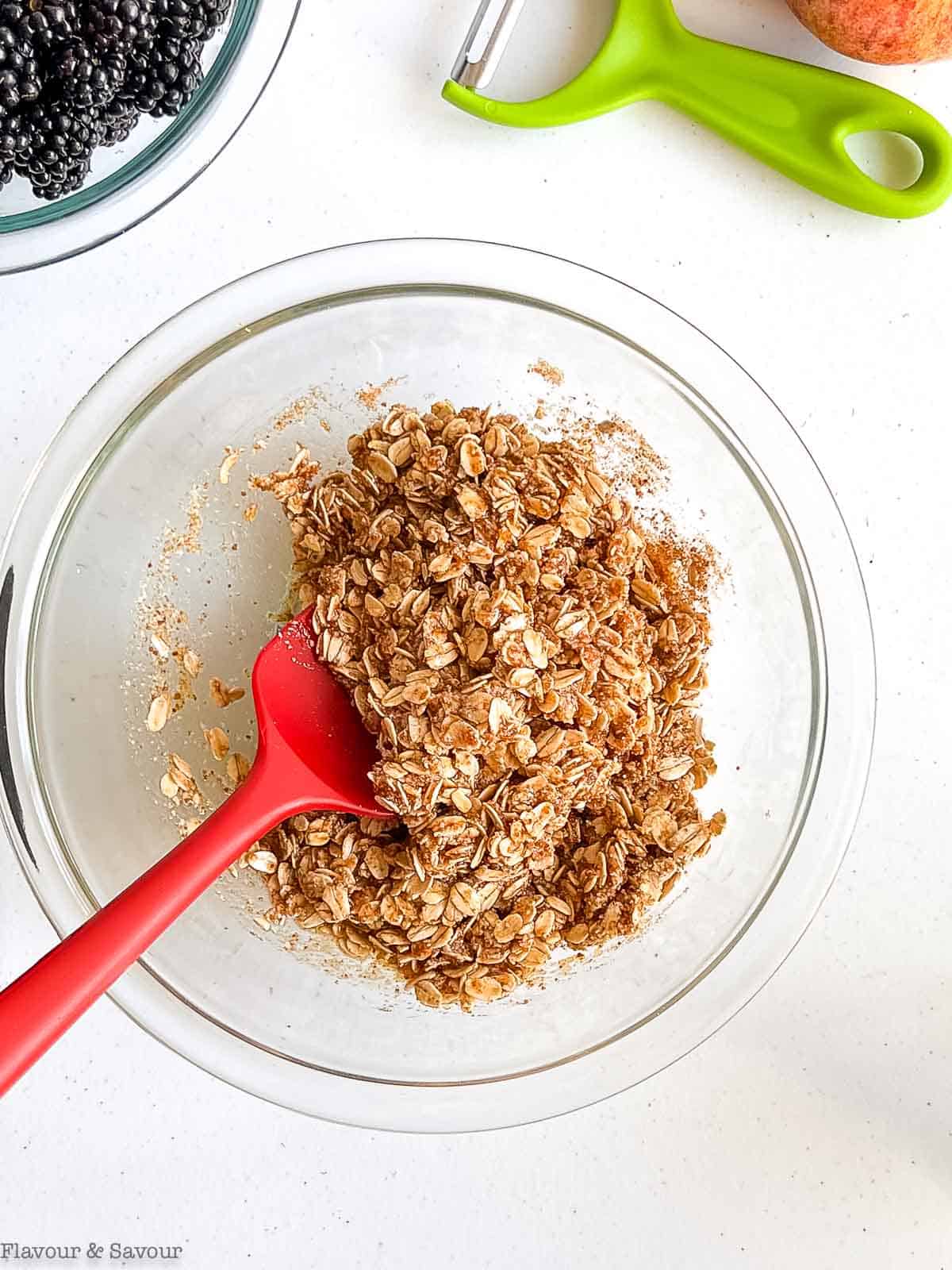 Crumble topping for apple blackberry crisp in a glass bowl.