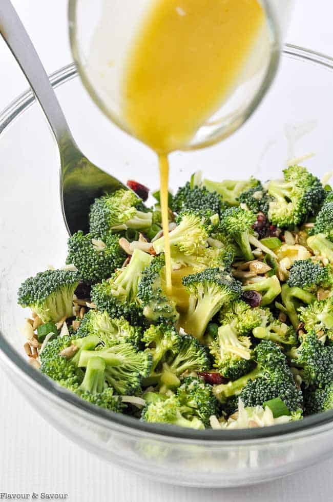 Pouring Honey-Mustard Dressing on Broccoli Cranberry Salad