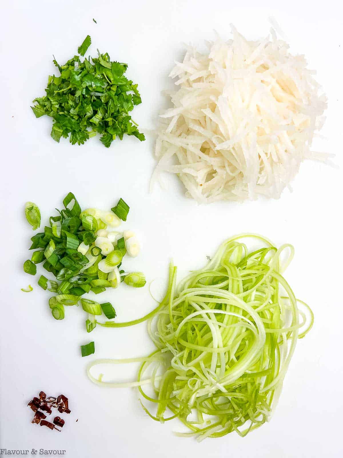 Ingredients for pear slaw prepared on a cutting board.