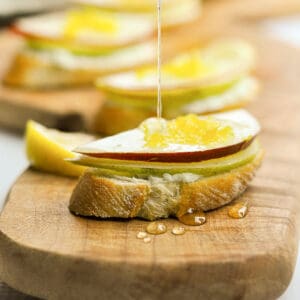 drizzling honey on pear and blue cheese crostini