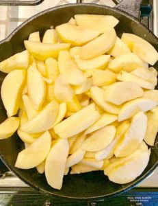 Sliced apples in cast iron skillet