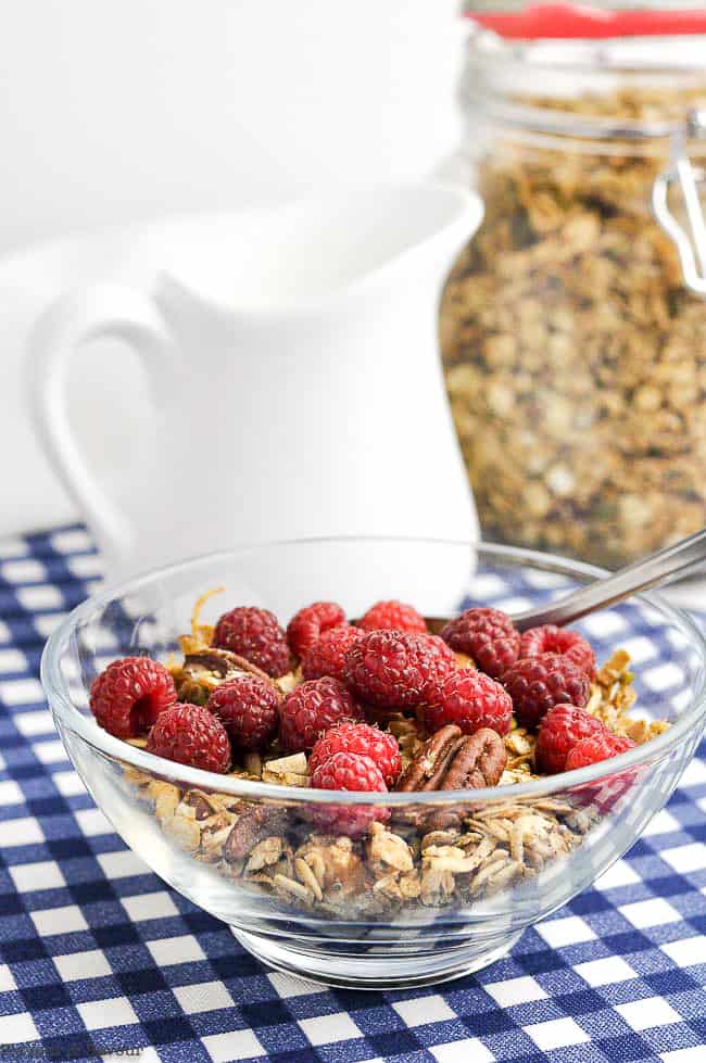 Pumpkin Spice Granola in a bowl with raspberries