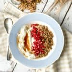 Overhead view of a blue bowl with Maple Nut Pumpkin Spice Granola