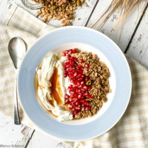 Overhead view of a blue bowl with Maple Nut Pumpkin Spice Granola