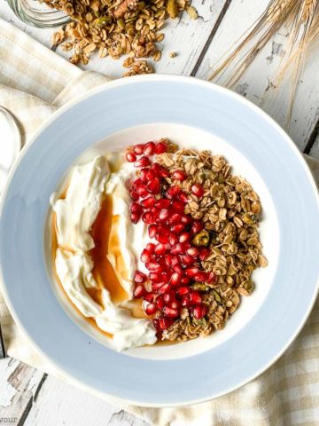 Overhead view of a blue bowl with Maple Nut Pumpkin Spice Granola