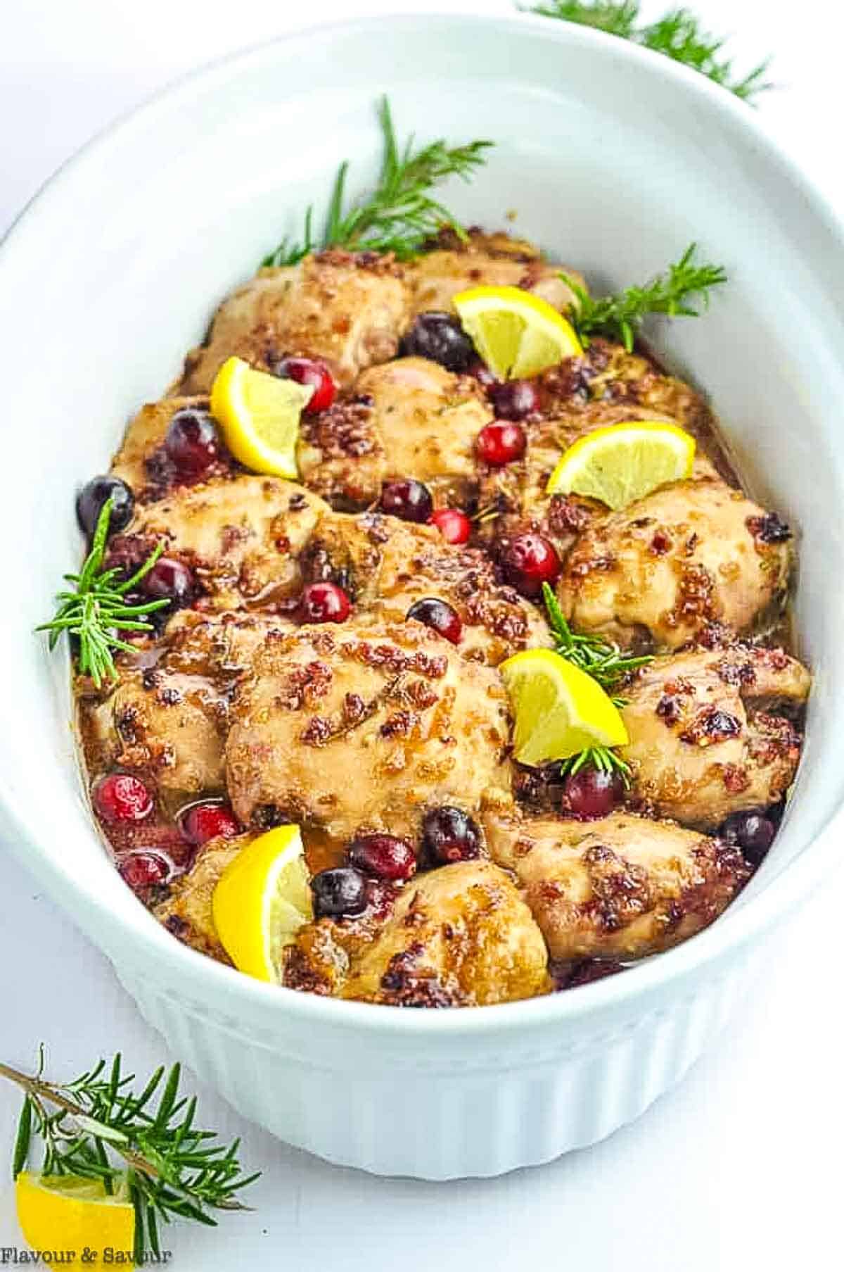 Cranberry Rosemary Chicken Thighs in a white serving bowl.