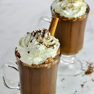 Two glass mugs of Cashew Milk Mexican Hot Chocolate